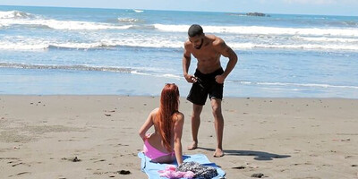 Running man finds cute redhead on the beach