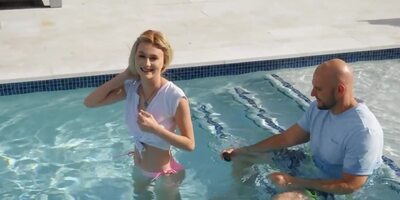 Tiny blonde facialized after sex with ball bruiser by the pool