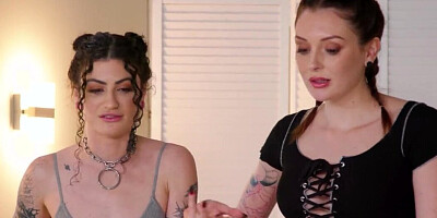 Tattooed brunette is getting a massage from a lesbian